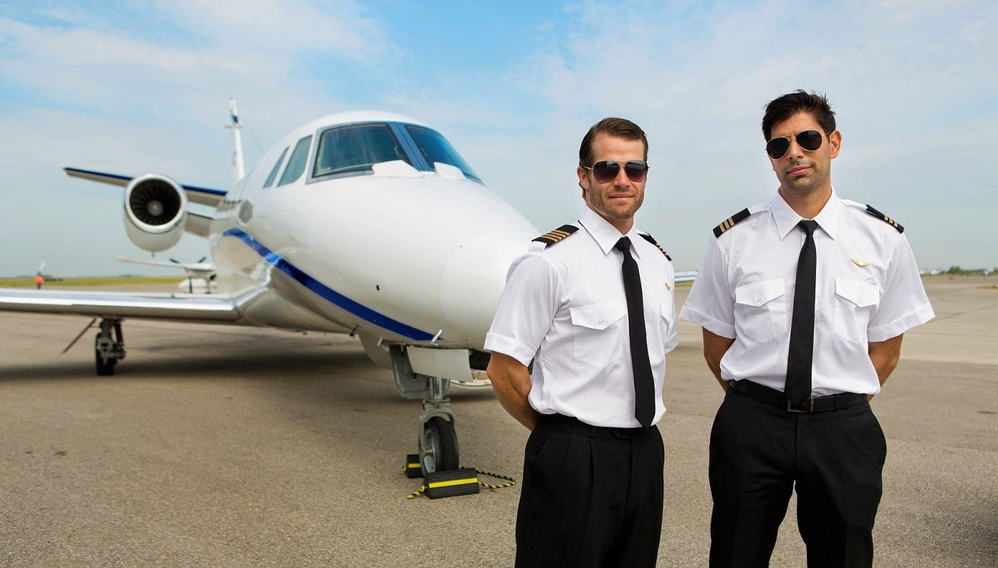 Portrait of confident pilots standing in front of private jet - The Right Pilot Seat For You