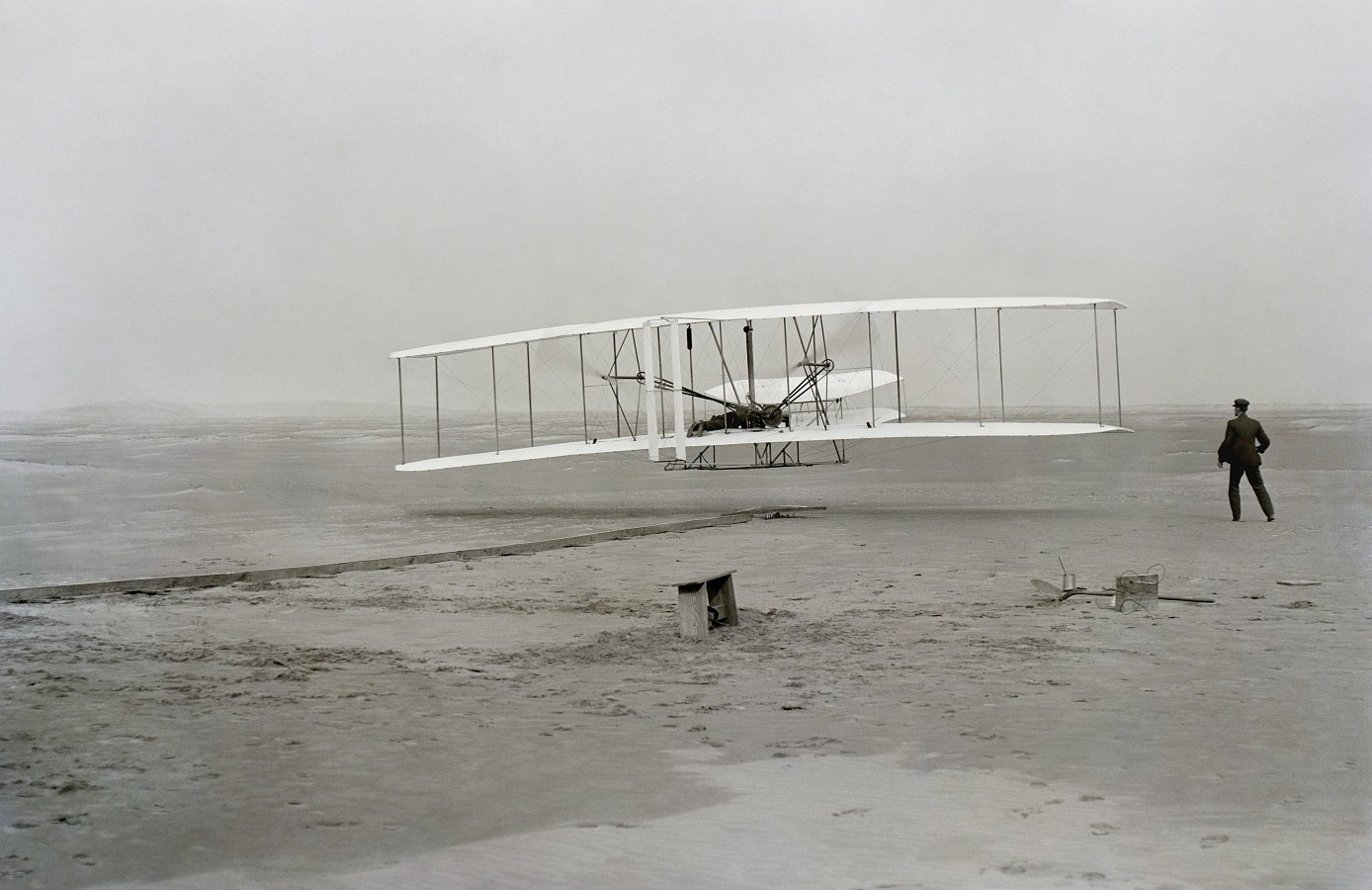 The historic photo captured by John T. Daniels of the Wright Brothers powered first flight - First Flight: the Wright Brothers