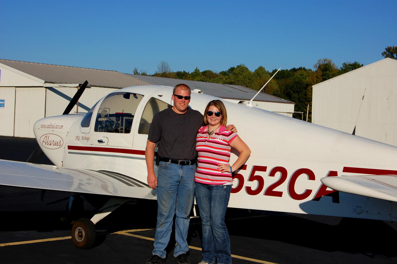 Student pilot and her father in front of a small aircraft - My Discovery Flight