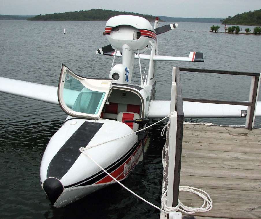 A seaplane tied up to a dock.