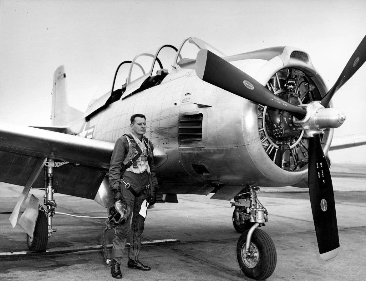 Bob Hoover standing next to a T28B aircraft.