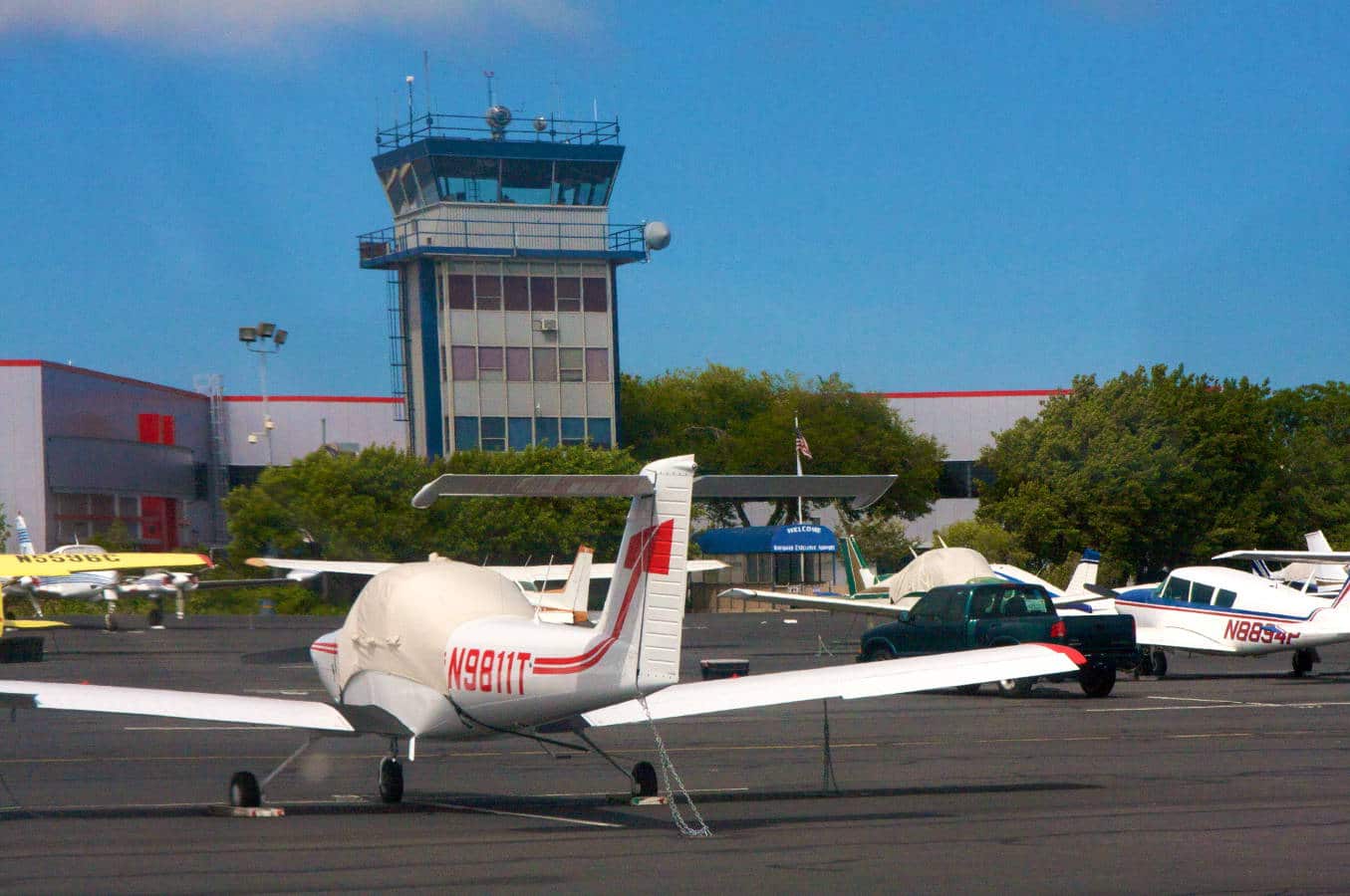 Small aircraft parked near an ATC tower - Follow Up on the FAA Hiring Scandal