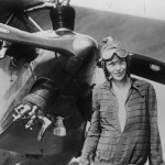 Amelia Earhart stands next to her Kinner Airster - What Happened to Amelia Earhart