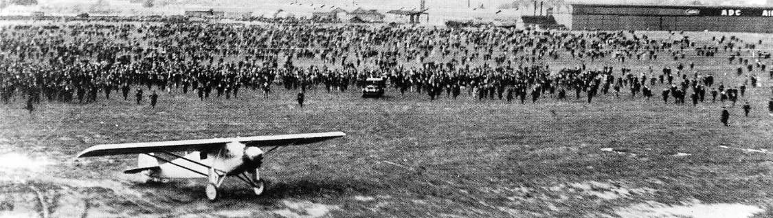 Crowds race to meet Charles Lindbergh after he lands the Spirit of St. Louis in England.