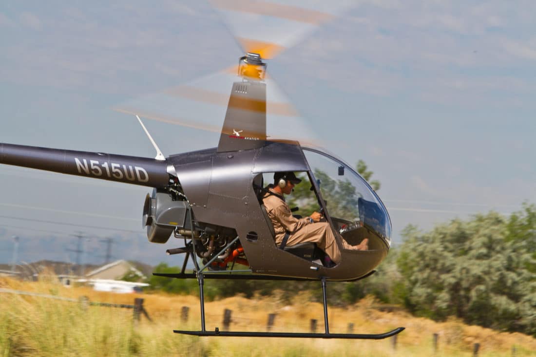 A Robinson R22 Helicopter flying.