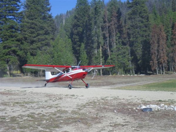 A Cessna 180 Skywagon on a dirt runway at Sulphur Creek