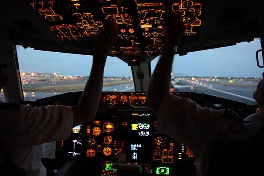 Pilots in the cockpit, prepping for evening flight - Are All Airline Pilot Training Schools the Same?