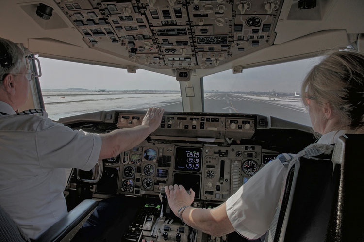 Male and Female Airline pilots in the cockpit