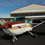 A small aircraft parked in front of a hangar - FAA's new policy on use of airport hangars takes effect July 1, 2017