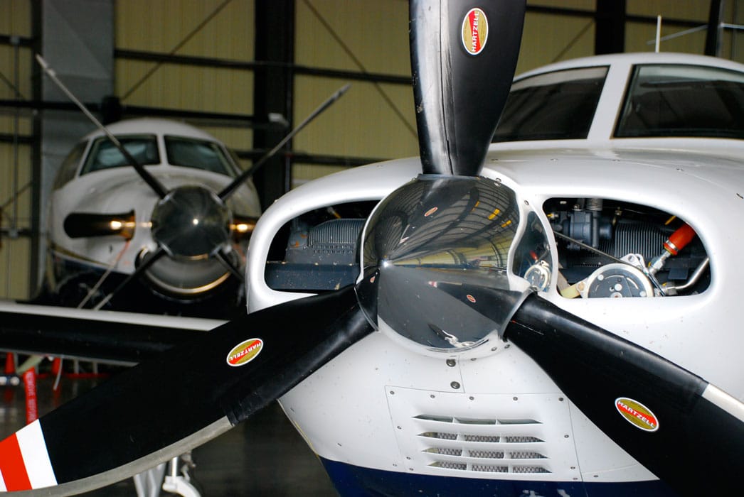 A pair of general aviation aircraft in a hangar - FAA and International Partners form Certification Management Team to streamline certification process