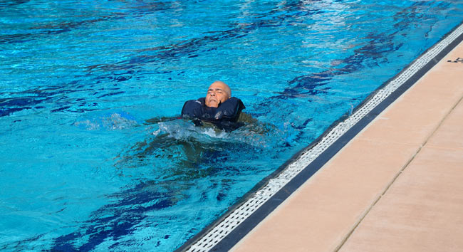 A general aviation pilot taking part in a swim test as part of training