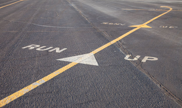 The arrows on a runway designating the run up area