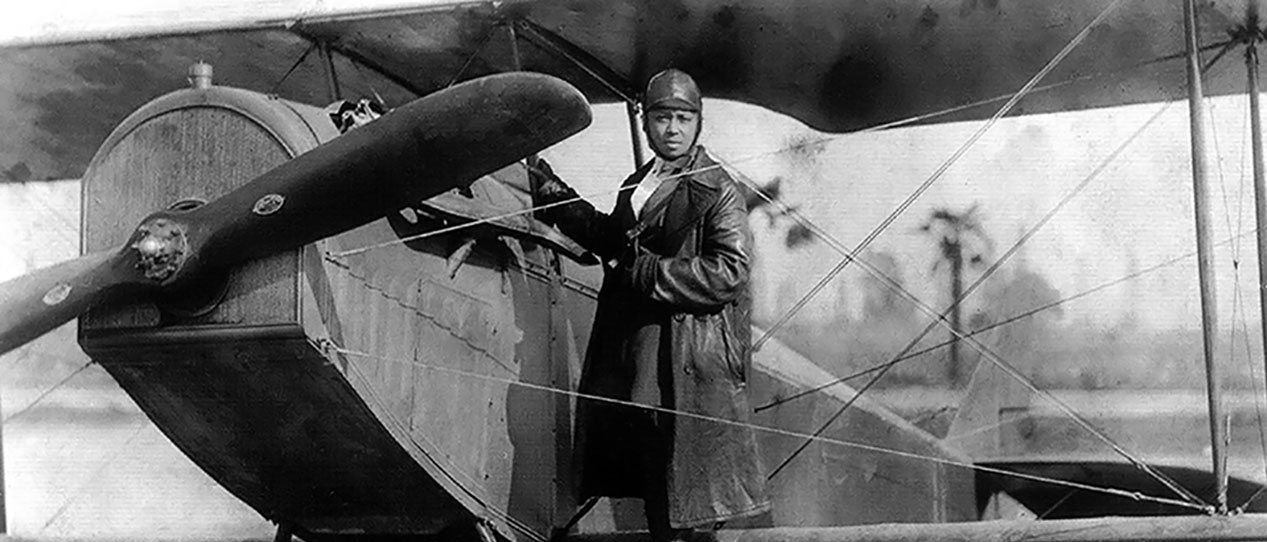 Bessie Coleman with her airplane