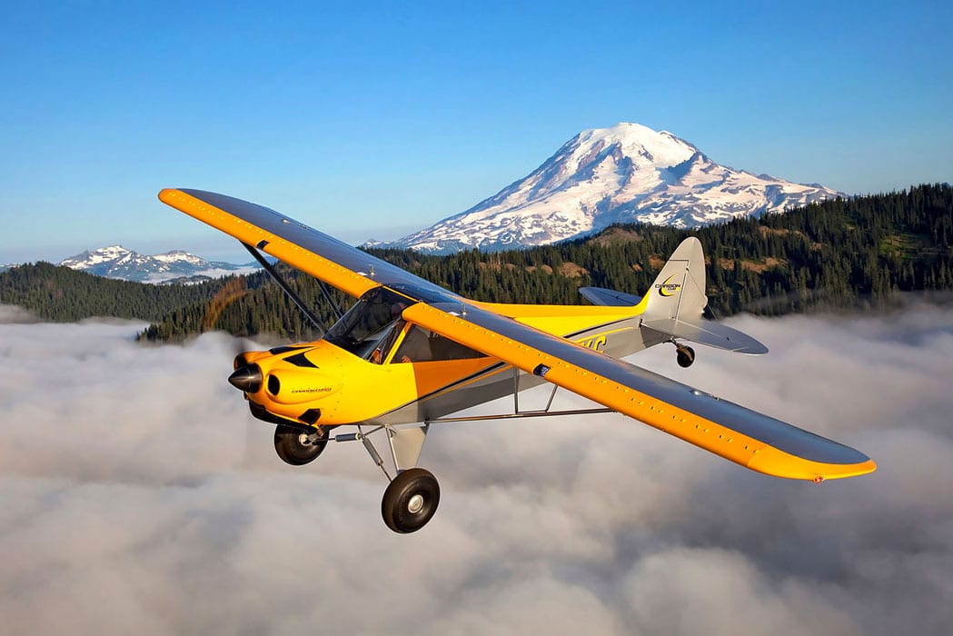 CubCrafters Carbon Cub SS in flight - CubCrafters announces new retrofit airframe parachute systems for select aircraft models