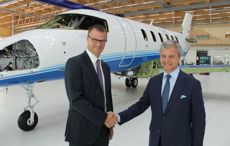 The first production model Pilatus PC-24 going through a wing fuselage marriage procedure, with PlaneSense CEO and PC-24 VP.