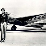 Amelia Earhart, posing with her plane. - Amelia Earhart Search