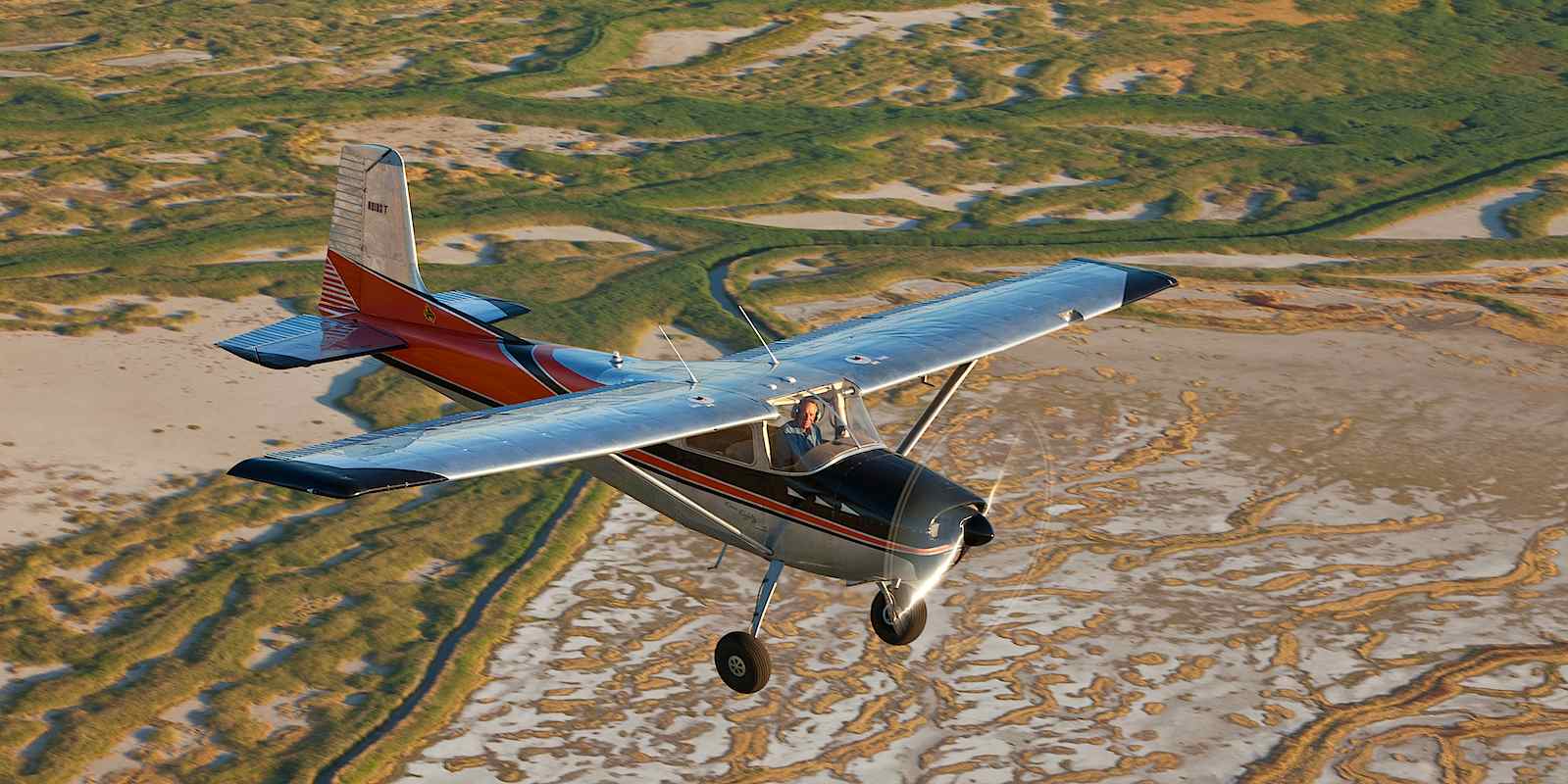 Mel Rozma flying his Cessna 180, part of his aviation dream.