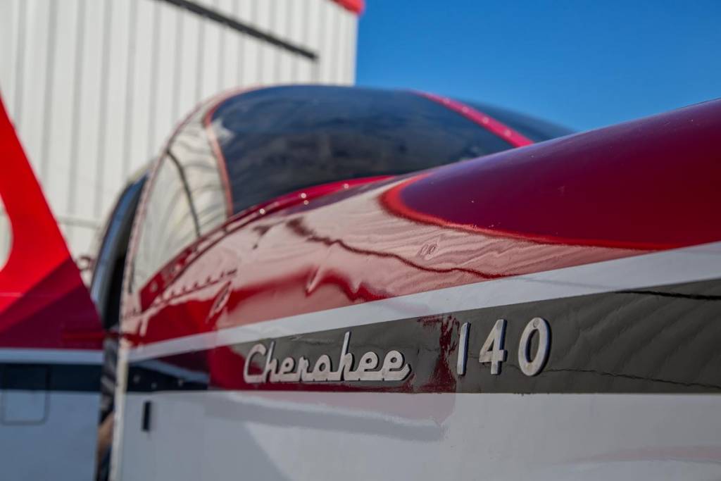 Cherokee 140 outside a hangar