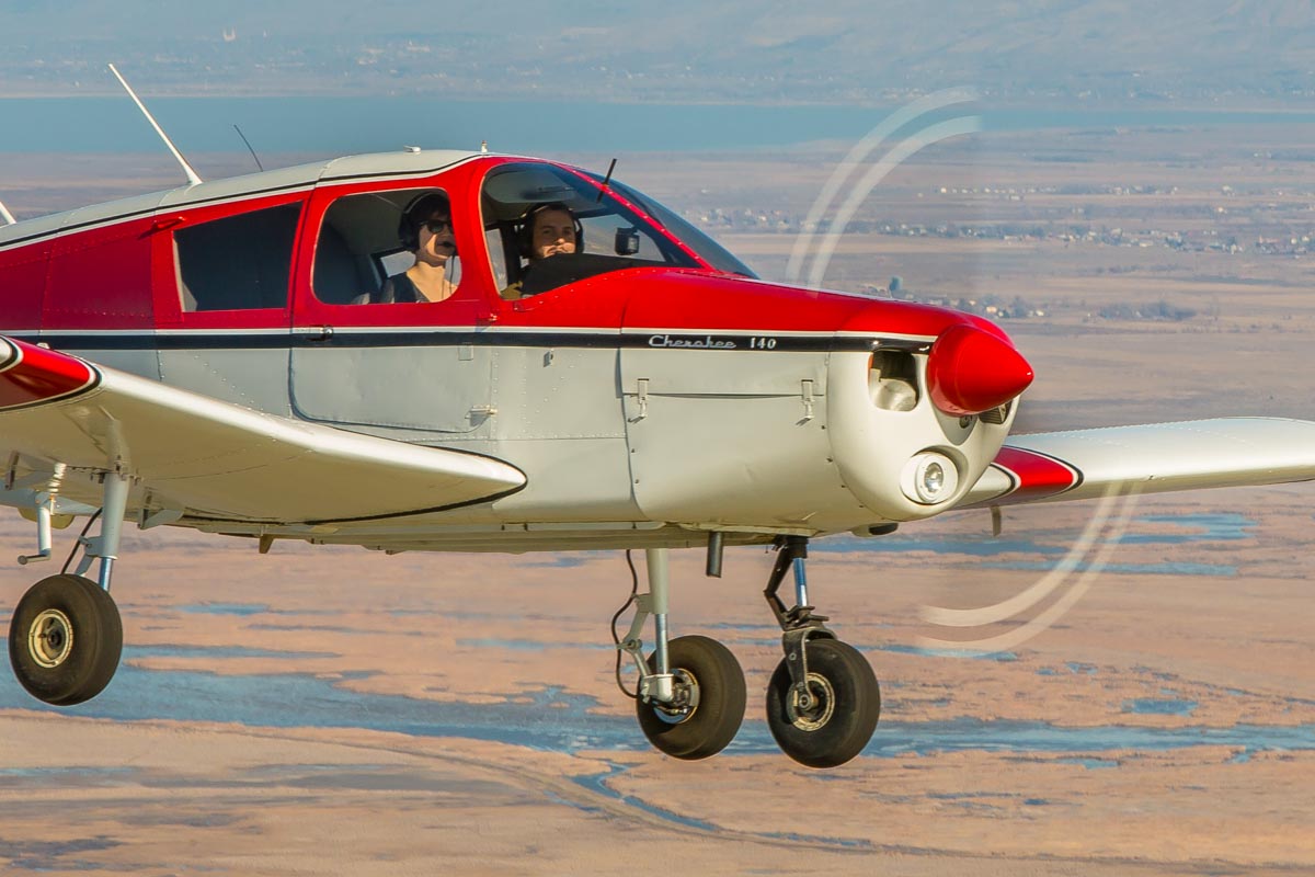 A Piper Cherokee 140 flying over the Great Salt Lake