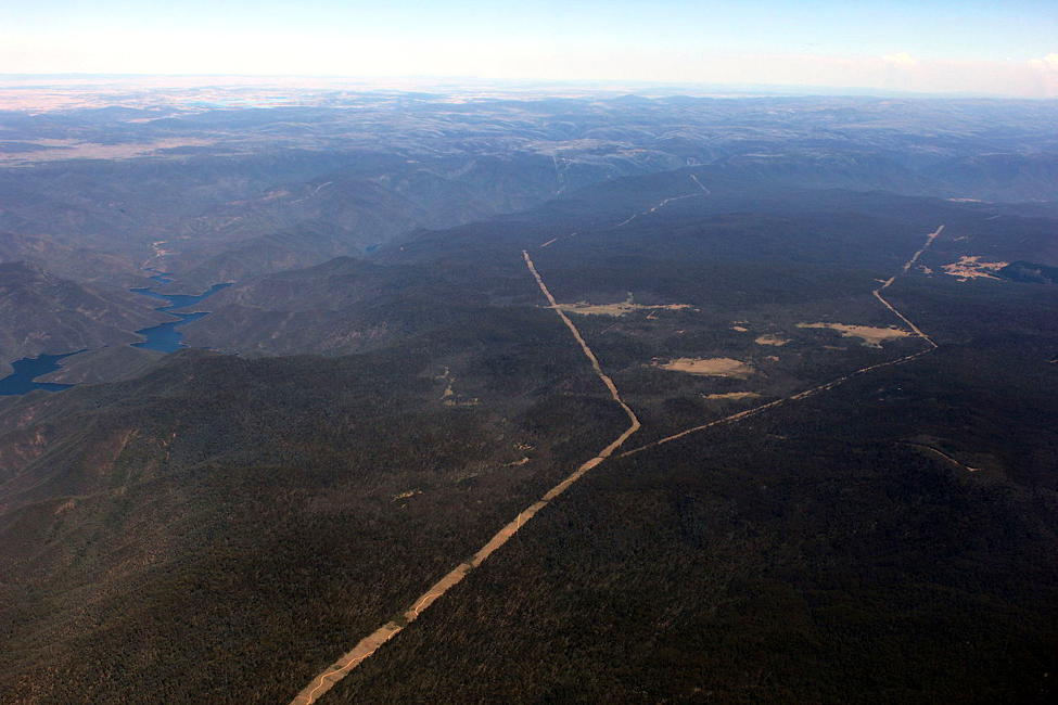 Aerial view of power line cuttings in a forest, which can tell pilots flying a helicopter where to watch for wires.