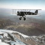 A Boeing Model 40A flying over a mountain range in the 1930s
