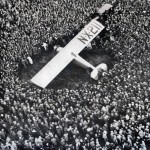 Charles Lindbergh lands the Spirit of St. Louis in France.