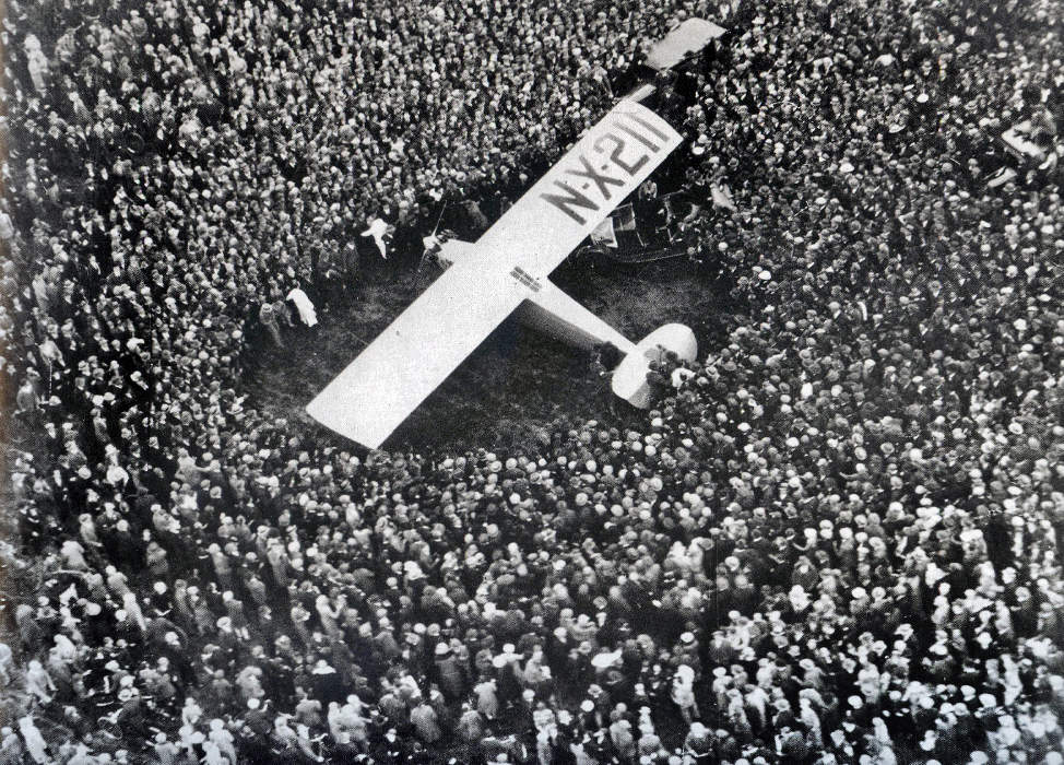 Charles Lindbergh lands the Spirit of St. Louis in France.