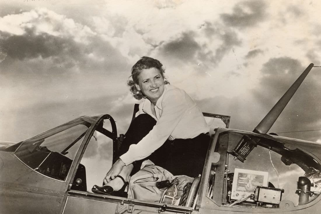 Jacqueline Cochran, or Jackie Cochran, emerging from the cockpit of an airplane.