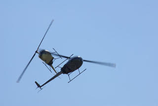 Two Robinson R22 Helicopters in flight.