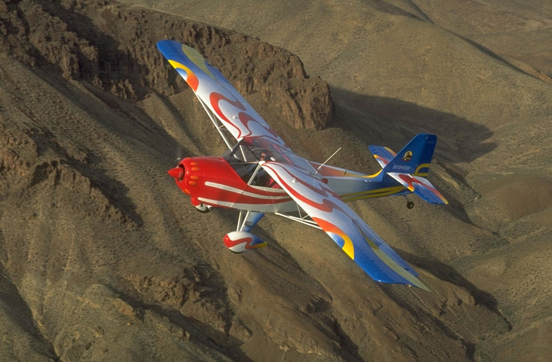 Kitfox flying over mountains