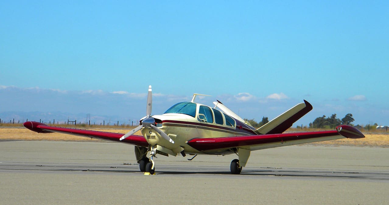 A Beechcraft Bonanza in parking at an airport - FAA's NORSEE Policy Promotes Installation of Safety Equipment