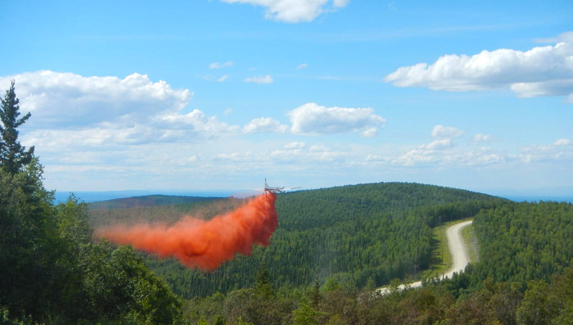 An aircraft dropping fire-retardant material