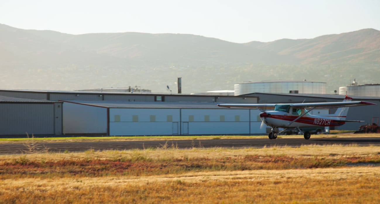 A certified flight instructor and student taking off in a Cessna 150