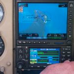 Man adjusting GPS input on an aircraft instrument panel - FAA Issues Flight Advisories for GPS Interference Testing