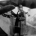 Bessie Coleman with her airplane