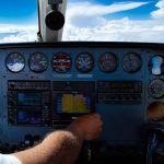 Pilot adjusting GPS on instrument panel of Cessna 421 - FAA Schedules 2017 GPS Interference Testing advisories