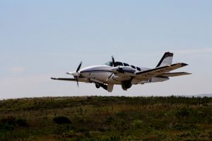 Bob Adams photo of a Beechcraft 58 Baron extending it's gear on landing.