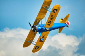 boeing-stearman model 75 in flight against a blue sky