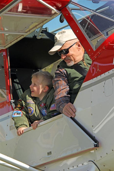 Bob Hoff and grandson in a Husky